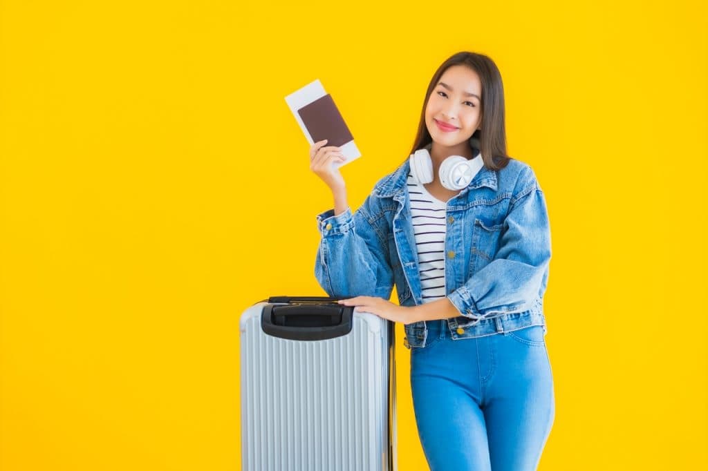 young-asian-woman-with-luggage-bag-passport